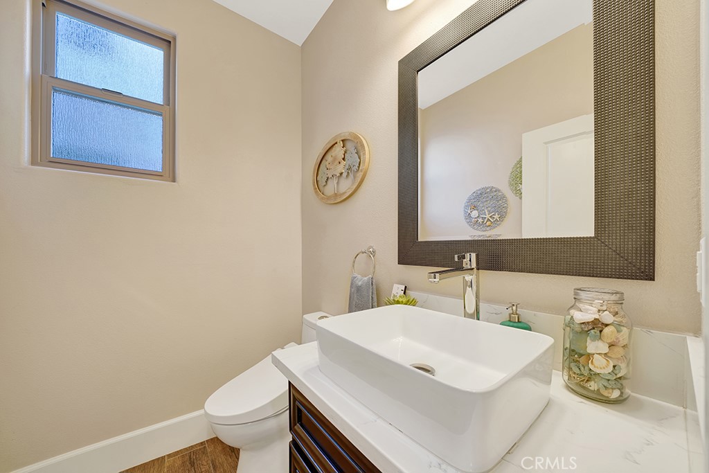 75 Marbella San Clemente, CA 92673 - Photo 19 of 54 a bathroom with a sink a toilet and a mirror