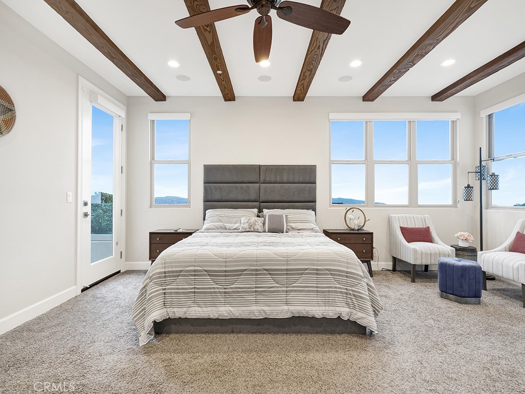 75 Marbella San Clemente, CA 92673 - Photo 35 of 54 a bedroom with a bed a couch and large window