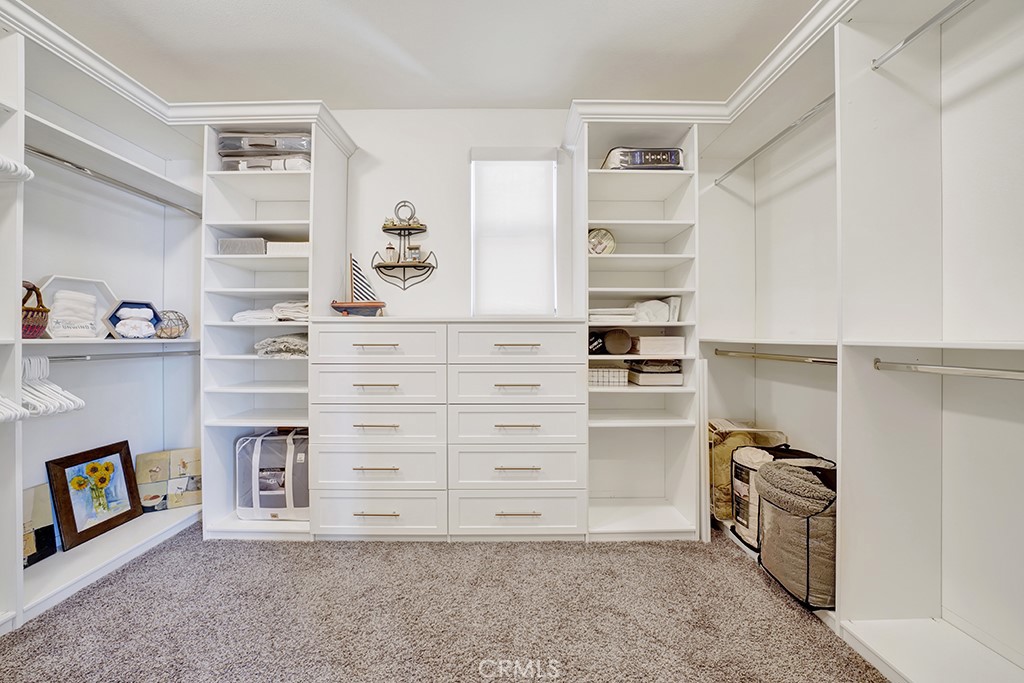 75 Marbella San Clemente, CA 92673 - Photo 39 of 54 a view of walk in closet with clothes and shoes