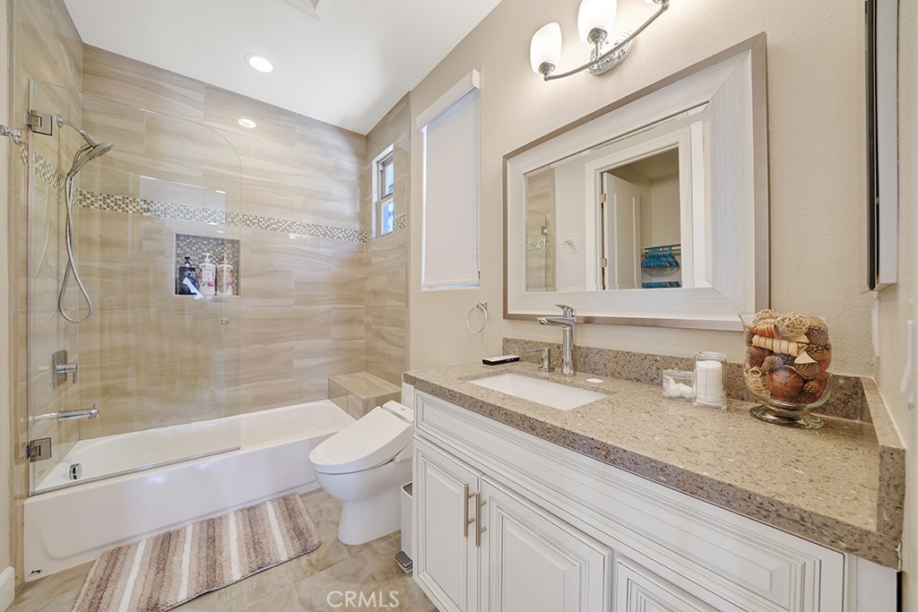 75 Marbella San Clemente, CA 92673 - Photo 45 of 54 a bathroom with a granite countertop sink a toilet and shower