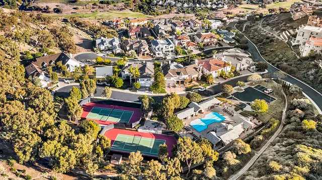 an aerial view of residential houses with outdoor space and street view