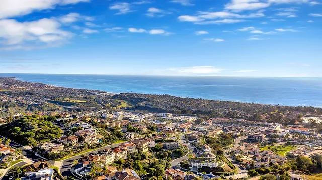 a living room with furniture a flat screen tv and a floor to ceiling window