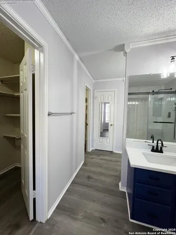 a view of an empty room and wooden floor