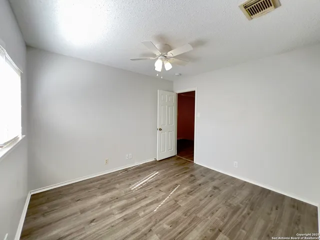 a bathroom with a bathtub shower sink vanity mirror and toilet