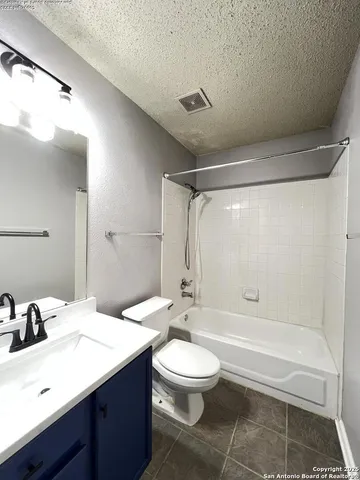 a view of backyard with wooden fence and large trees