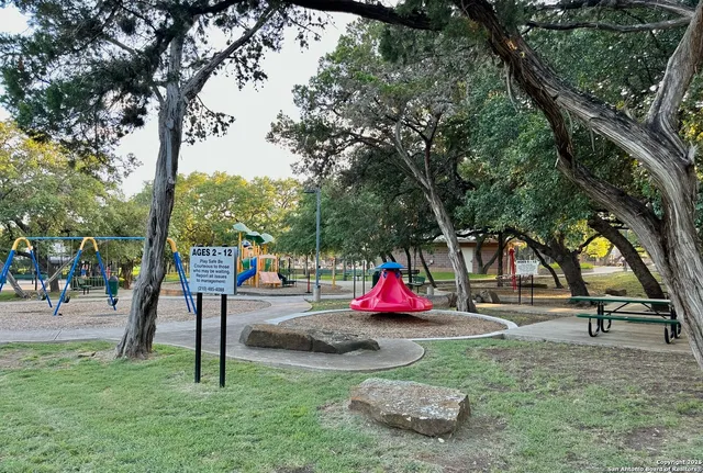 a view of a park with iron fence