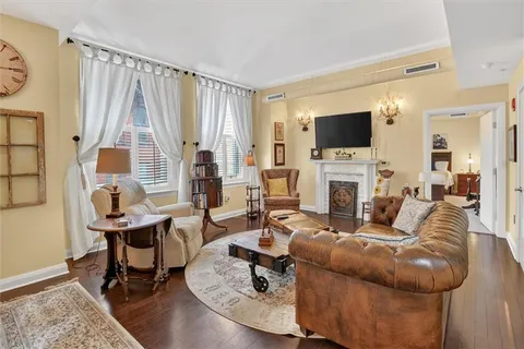 a living room with fireplace furniture and a flat screen tv