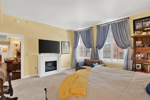 a bedroom with a bed a flat screen tv and a fish tank