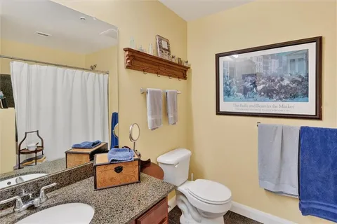 a bathroom with a toilet sink and mirror