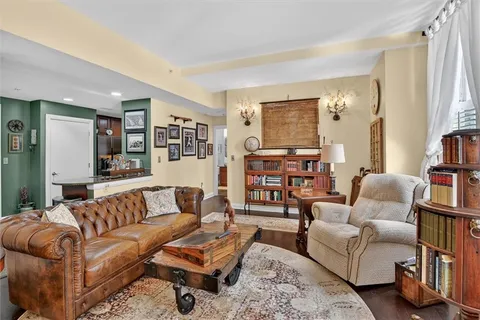 a living room with furniture and a book shelf