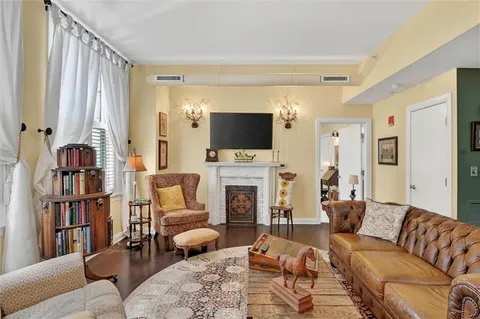 a living room with furniture a fireplace and a flat screen tv