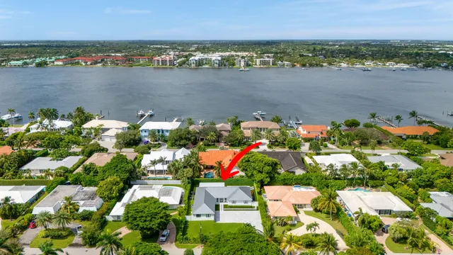 an aerial view of lake and houses with outdoor seating