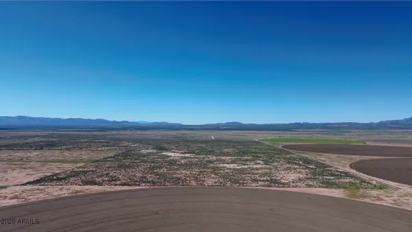a view of an ocean beach and mountain