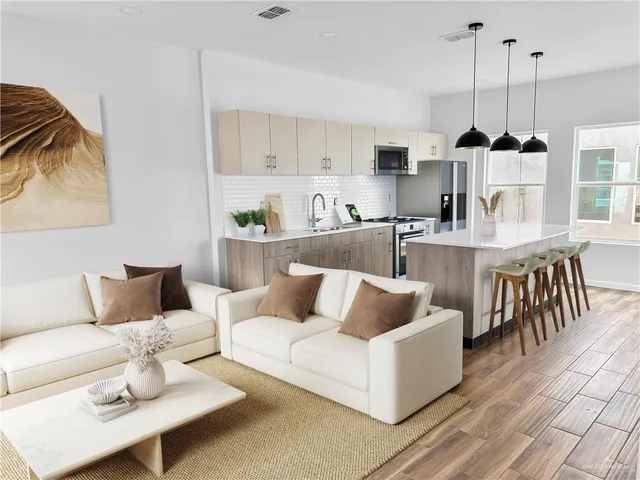 a living room with furniture and a chandelier