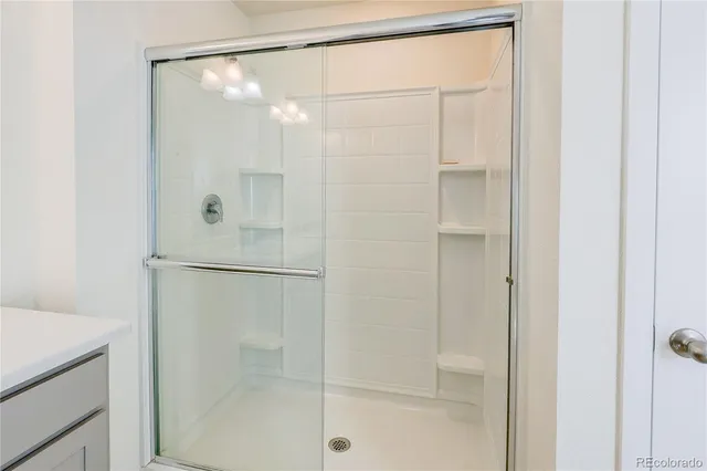 a bathroom with a glass shower door