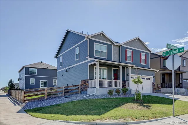 a front view of a house with a garden and plants