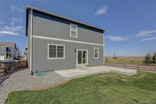 a front view of a house with a yard and seating space
