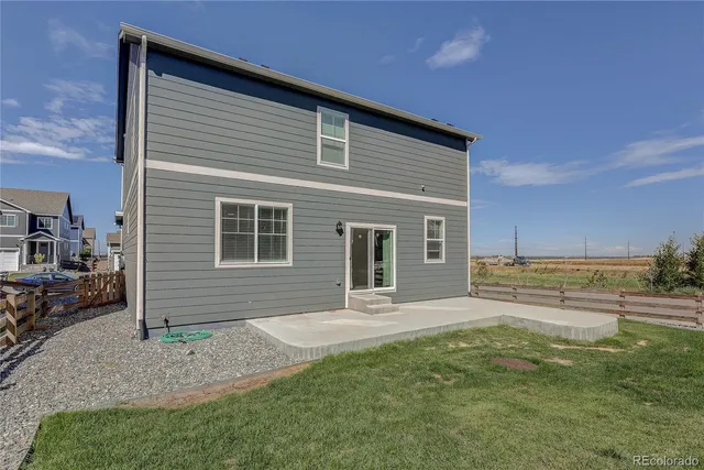 a front view of a house with a yard and seating space