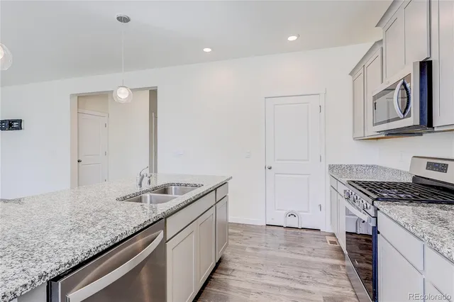 a kitchen with granite countertop a sink and cabinets