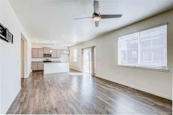 a view of kitchen with wooden floor electronic appliances and window