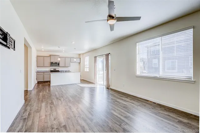 a view of kitchen with wooden floor electronic appliances and window