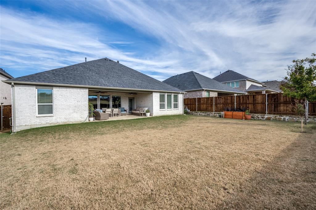 337 Augusta Court Oak Point, TX 75068 - Photo 22 of 26 a front view of a house with a garden
