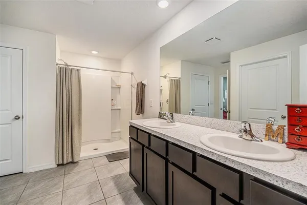 a bathroom with a sink double vanity and a mirror