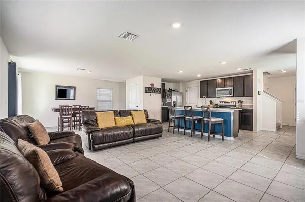 a living room with furniture and kitchen view