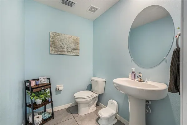 a bathroom with a toilet a sink and a mirror