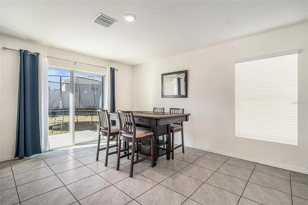a dining room with furniture and window