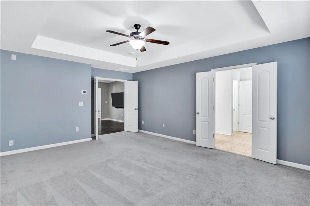 330 Avalon Square Fairburn, GA 30213 - Photo 24 of 52 a view of an empty room with a ceiling fan