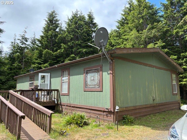 56399 Christopher Road Bandon, OR 97411 - Photo 2 of 34 a front view of a house with garden