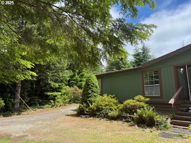 56399 Christopher Road Bandon, OR 97411 - Photo 23 of 34 a house with a lot of plants