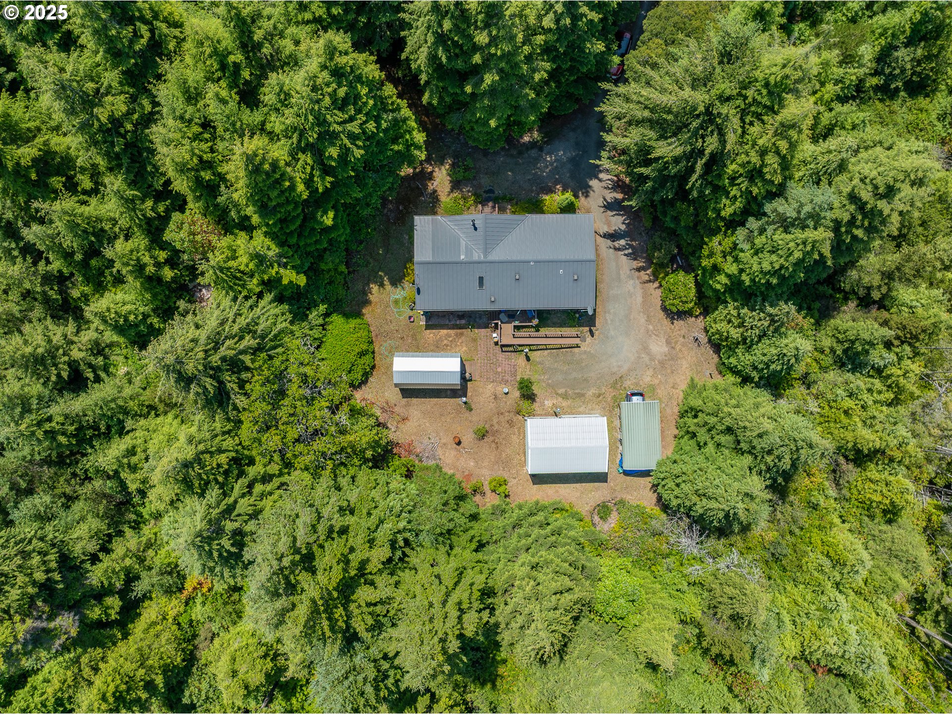 56399 Christopher Road Bandon, OR 97411 - Photo 28 of 34 an aerial view of a house with a yard