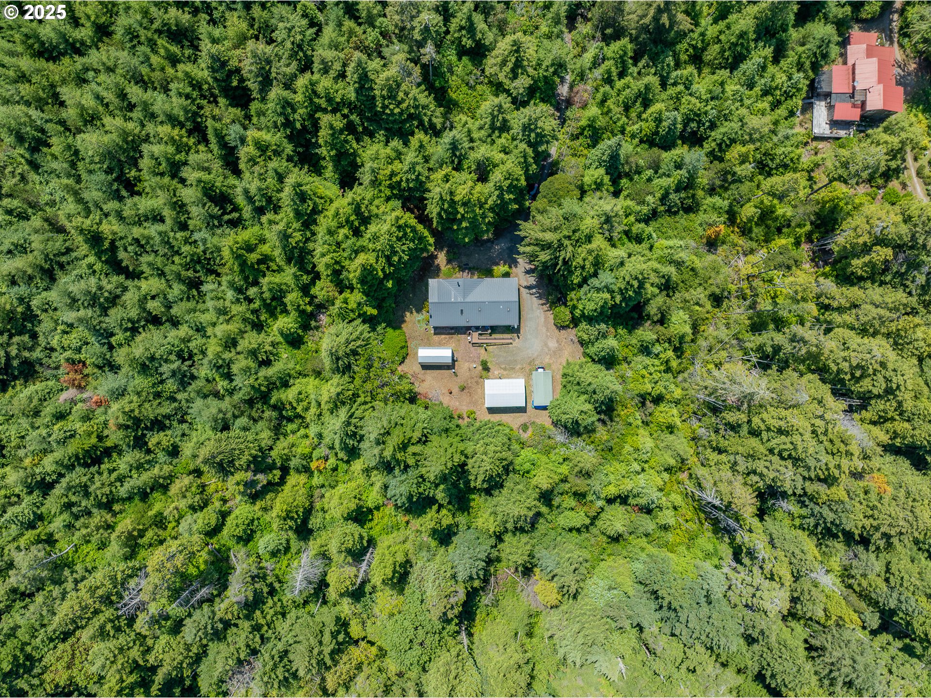 56399 Christopher Road Bandon, OR 97411 - Photo 29 of 34 a view of a house with a yard
