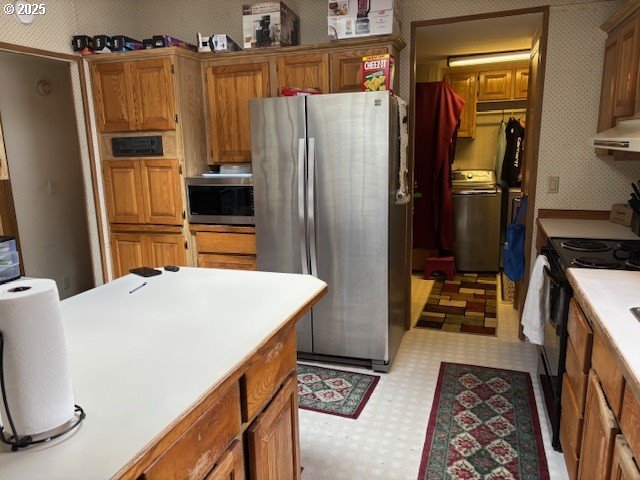 56399 Christopher Road Bandon, OR 97411 - Photo 7 of 34 a kitchen with stainless steel appliances a refrigerator and a stove
