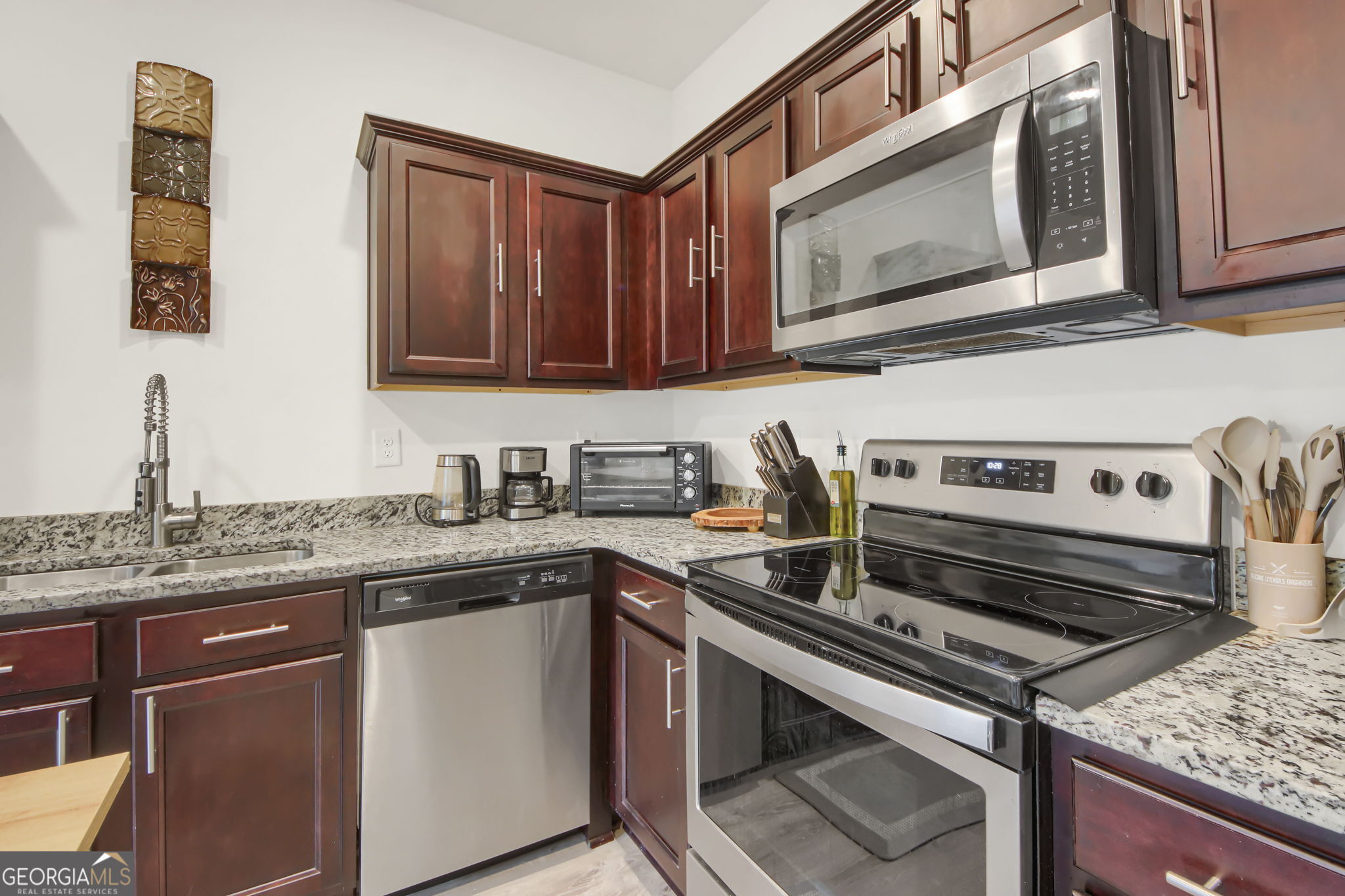 11924 Fuller Street Hampton, GA 30228 - Photo 11 of 26 a kitchen with a stove microwave and sink