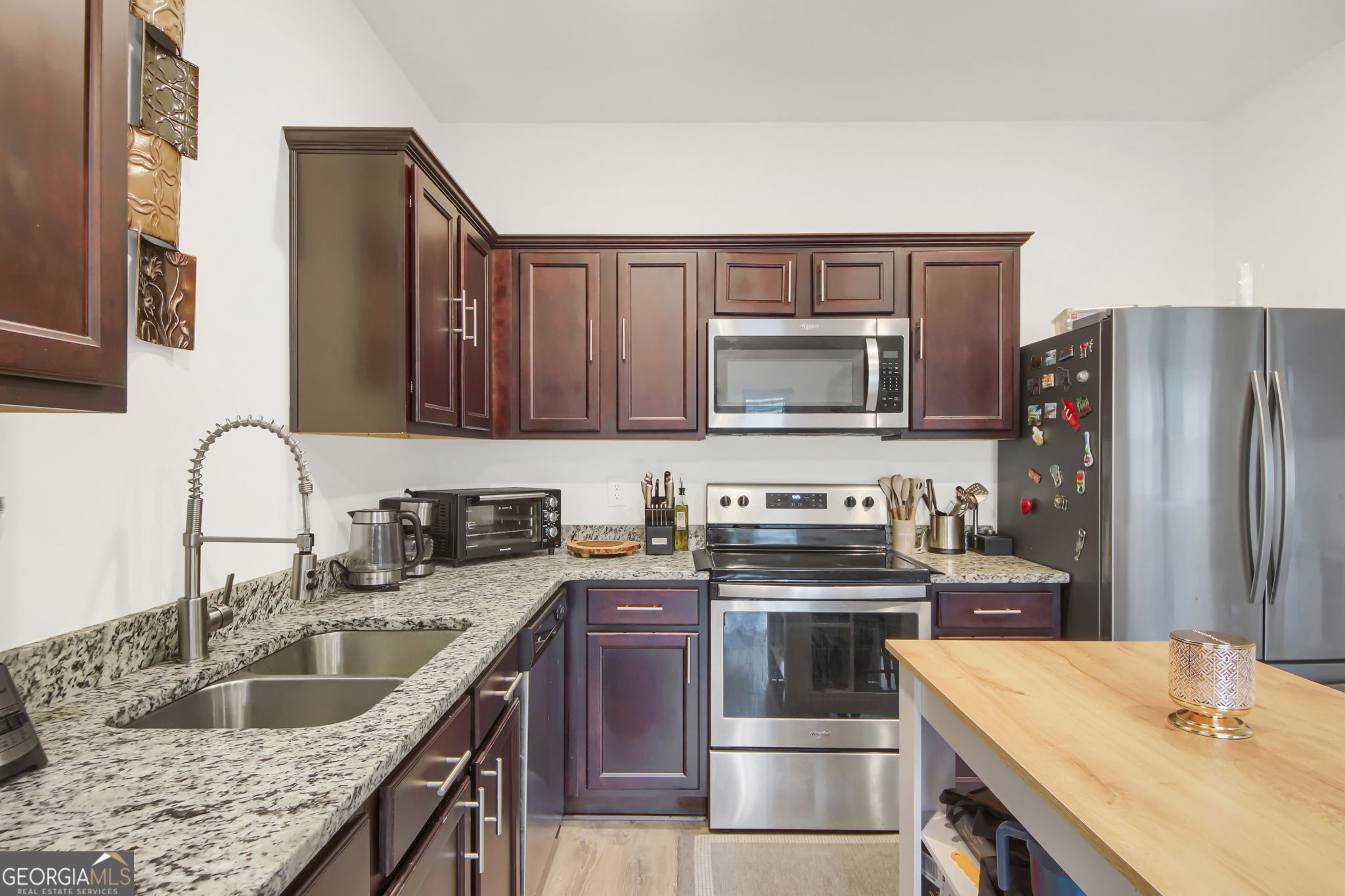 11924 Fuller Street Hampton, GA 30228 - Photo 12 of 26 a kitchen with granite countertop a sink stove and refrigerator