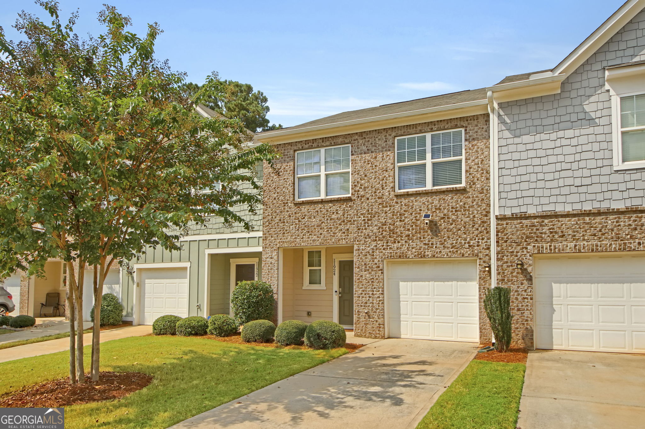 11924 Fuller Street Hampton, GA 30228 - Photo 2 of 26 a front view of a house with a yard and garage