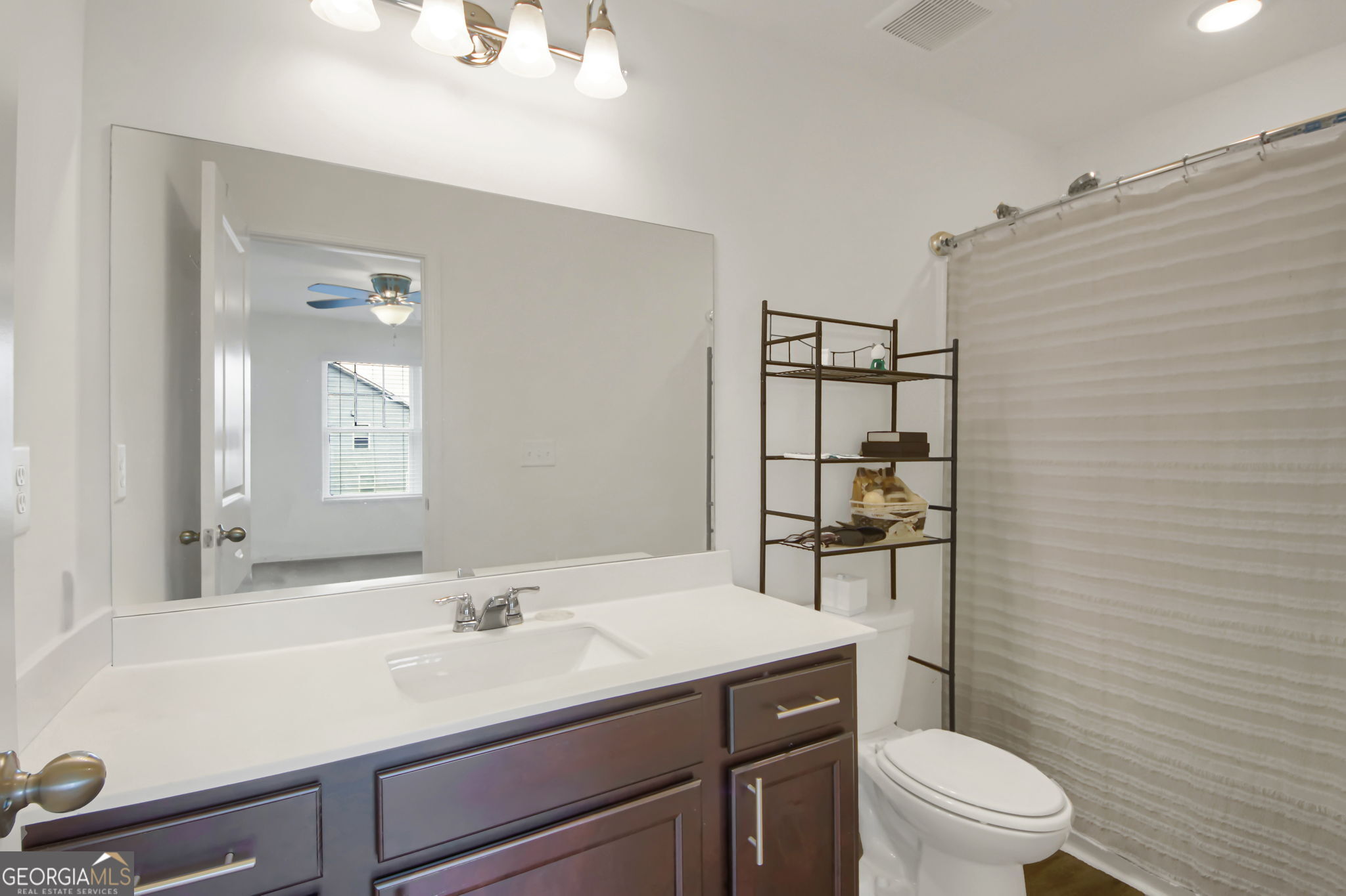 11924 Fuller Street Hampton, GA 30228 - Photo 22 of 26 a bathroom with a sink a toilet and shower