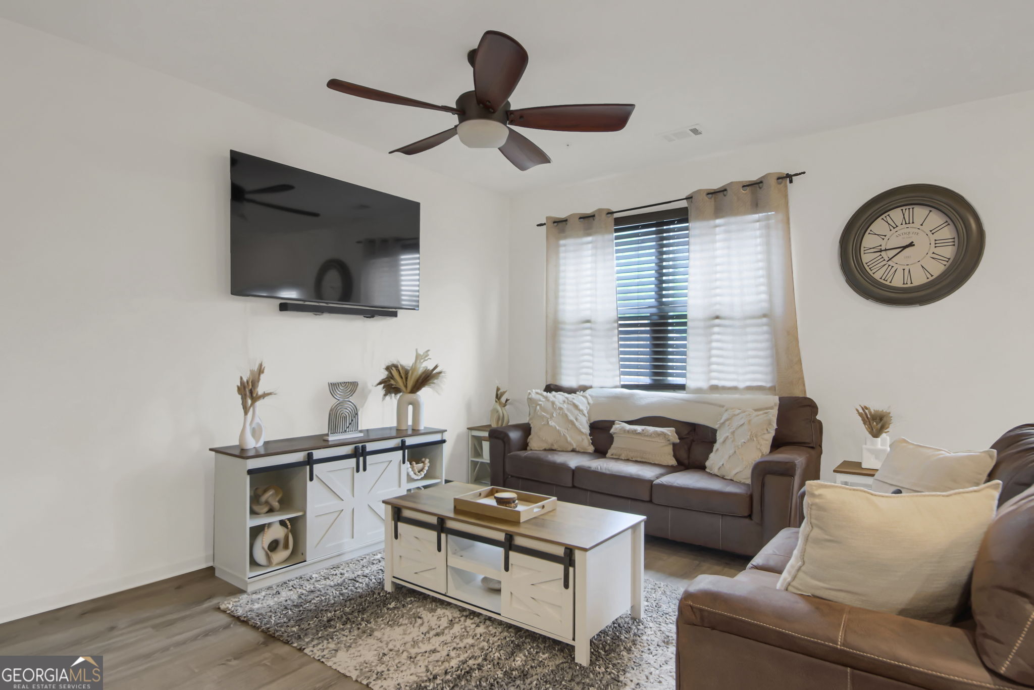11924 Fuller Street Hampton, GA 30228 - Photo 7 of 26 a living room with furniture a flat screen tv and a window
