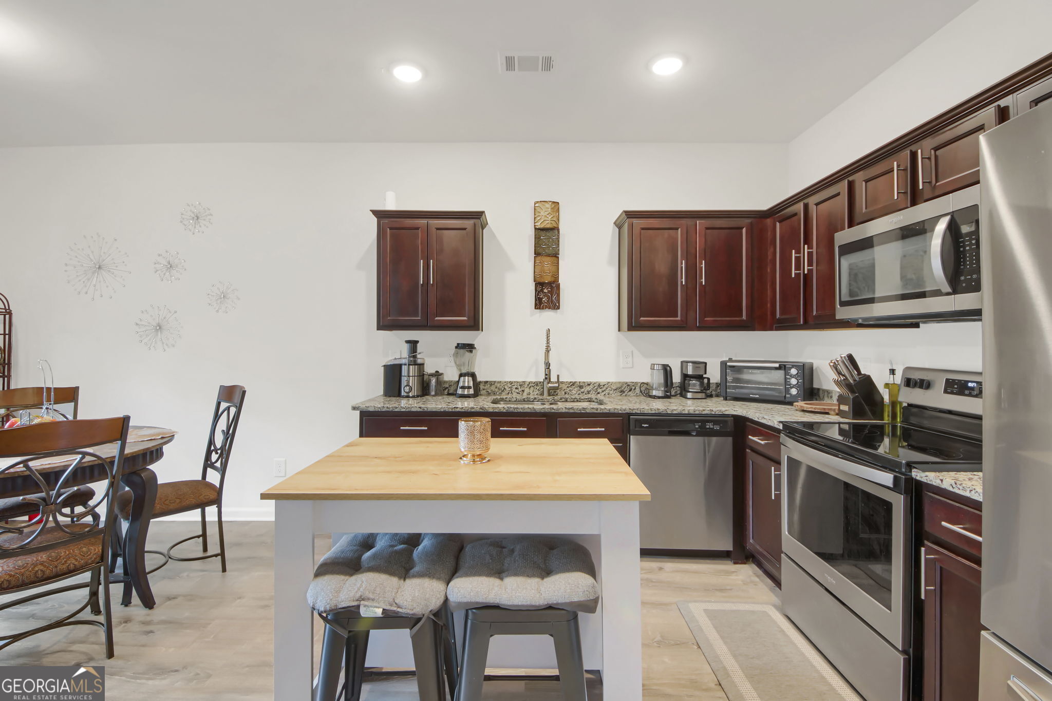 11924 Fuller Street Hampton, GA 30228 - Photo 9 of 26 a kitchen with a sink stove and microwave