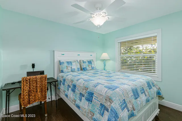 a bedroom with a bed a window and dresser