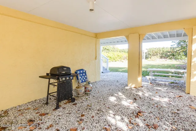 a view of a room with gym equipment and large windows