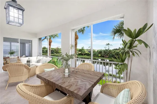 a living room with patio furniture and a potted plants