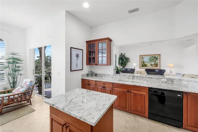 a kitchen with stainless steel appliances granite countertop stove a sink and a refrigerator