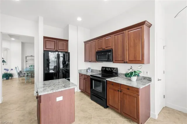 a kitchen with stainless steel appliances granite countertop a stove top oven a sink and dishwasher