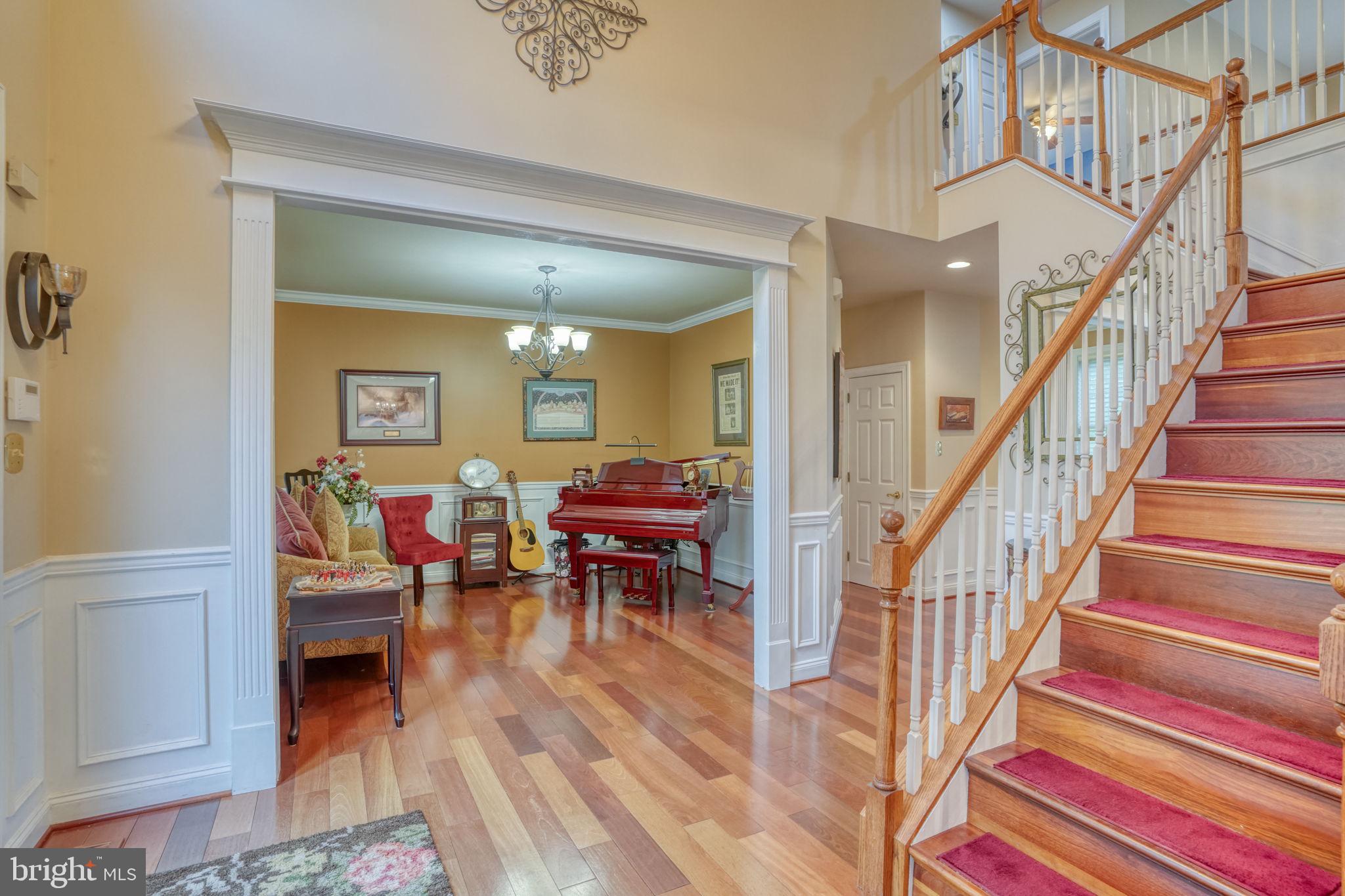 357 Willits Way Garnet Valley, PA 19060 - Photo 5 of 63 a view of a hallway with dining room and wooden floor