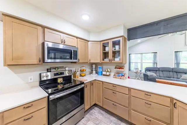 a kitchen with stainless steel appliances a sink stove and microwave