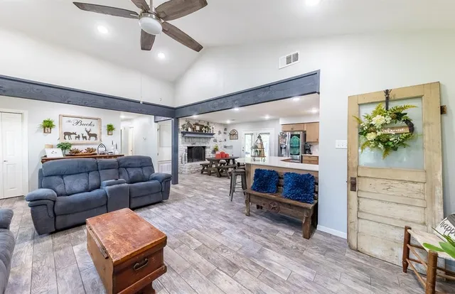 a living room with furniture and a wooden floor